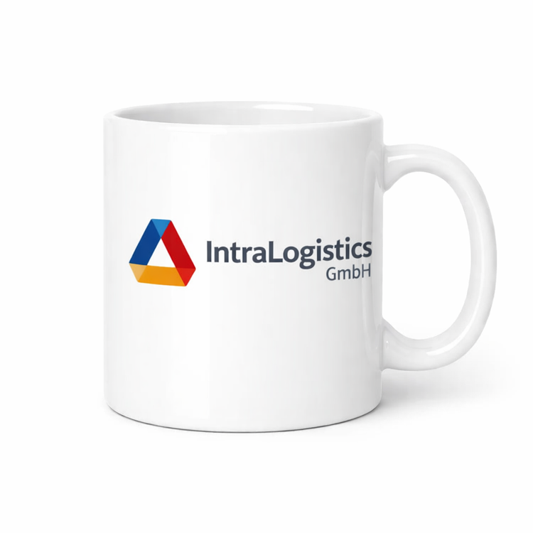 Weiße Werbetasse aus Keramik mit IntraLogistics GmbH Logo, Frontansicht mit rechtem Henkel, ideal als Firmenbecher für Büro und Promotion